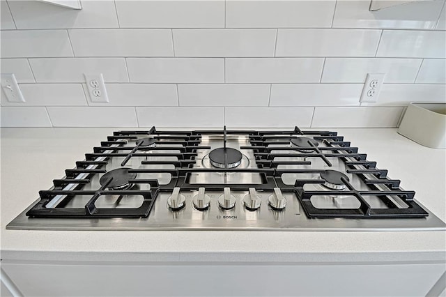 interior details with gas cooktop and decorative backsplash