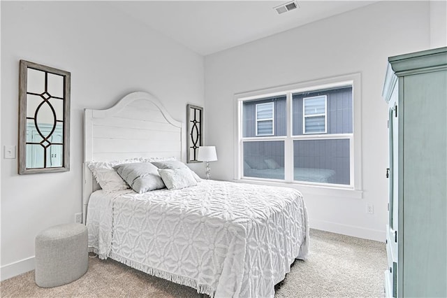 bedroom with light colored carpet