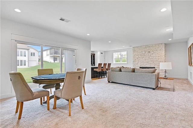 dining area featuring light carpet