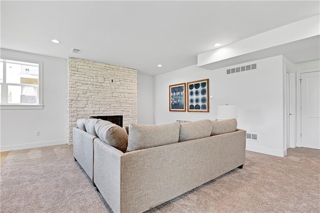 carpeted living room featuring a fireplace