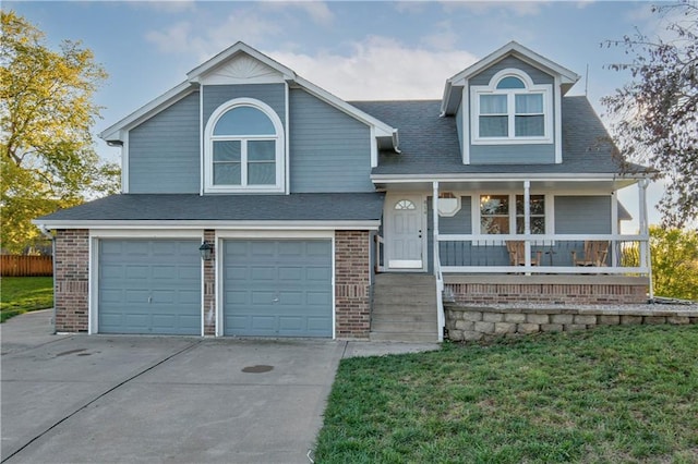 view of front of home with a porch, a garage, and a front lawn