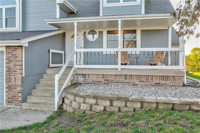 view of exterior entry featuring a porch