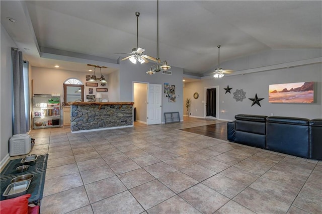 kitchen with ceiling fan, light tile patterned flooring, and vaulted ceiling