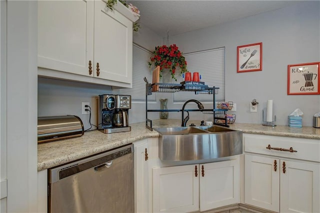 kitchen with white cabinetry, sink, and stainless steel dishwasher