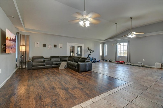 unfurnished living room featuring french doors, light hardwood / wood-style floors, ceiling fan, and lofted ceiling