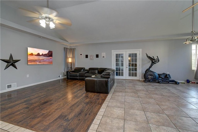 living room with french doors, vaulted ceiling, light hardwood / wood-style flooring, and ceiling fan