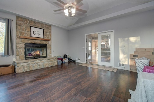 living room featuring a fireplace, lofted ceiling, ceiling fan, and dark wood-type flooring