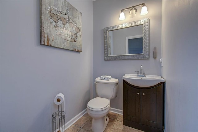 bathroom featuring tile patterned flooring, vanity, and toilet