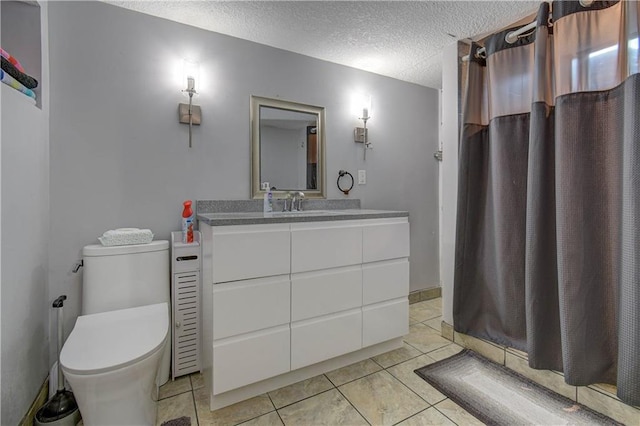 bathroom with tile patterned floors, vanity, a shower with curtain, and a textured ceiling