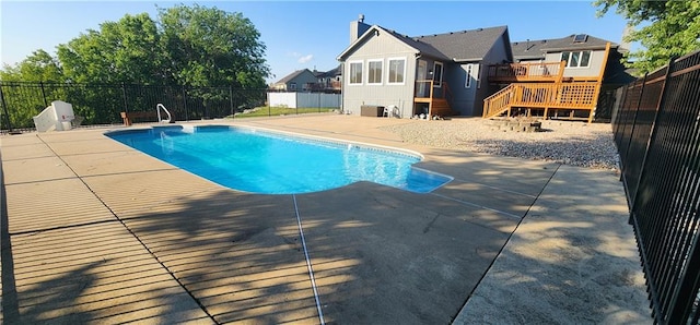 view of swimming pool with a patio area and a wooden deck