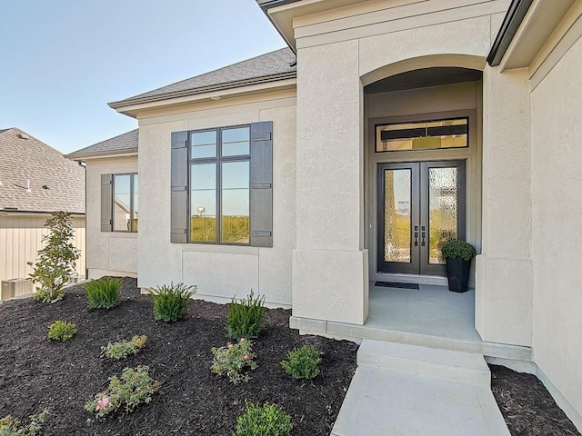 view of exterior entry featuring french doors