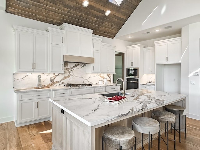 kitchen featuring stainless steel appliances, white cabinetry, and a large island