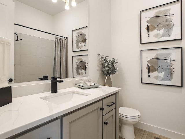 bathroom with hardwood / wood-style flooring, vanity, toilet, and a shower with shower curtain