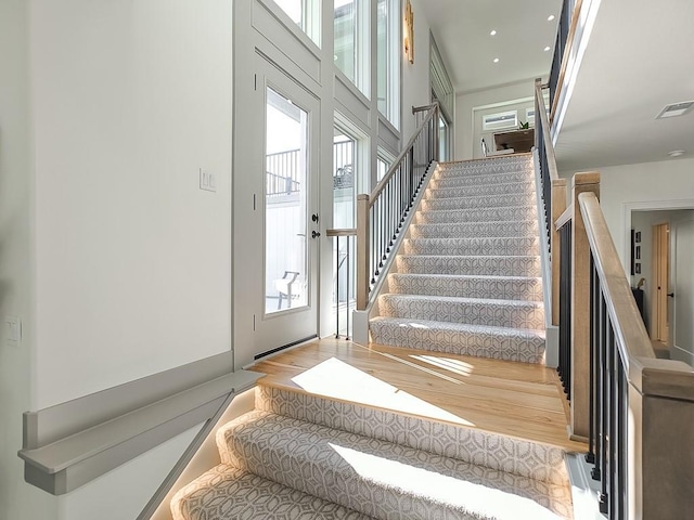 staircase with french doors and hardwood / wood-style flooring