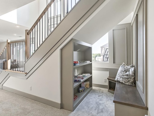 interior space featuring carpet floors and lofted ceiling