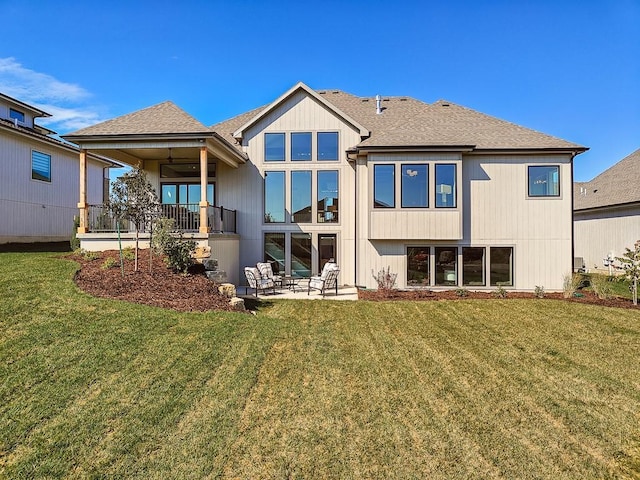 back of house with a patio and a lawn