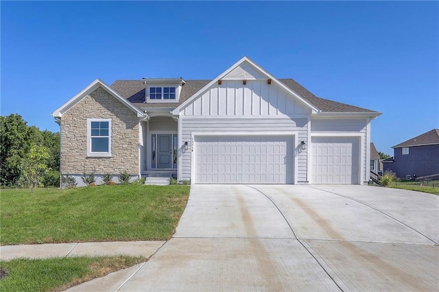 view of front of property with board and batten siding, concrete driveway, a front yard, stone siding, and an attached garage