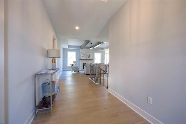 corridor featuring recessed lighting, baseboards, and light wood finished floors