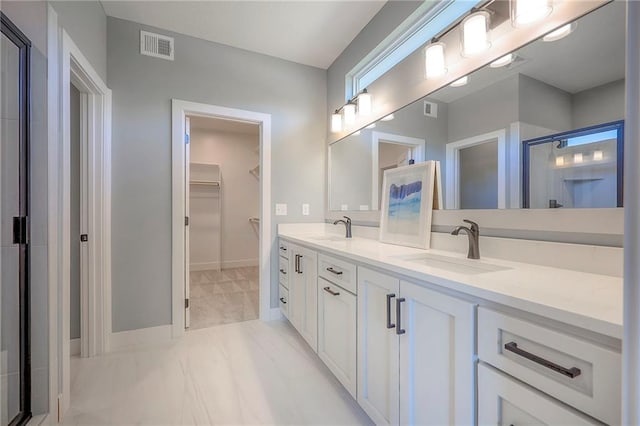 full bath with a sink, visible vents, double vanity, and a spacious closet