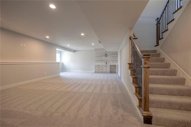 interior space with recessed lighting, stairway, baseboards, and light colored carpet