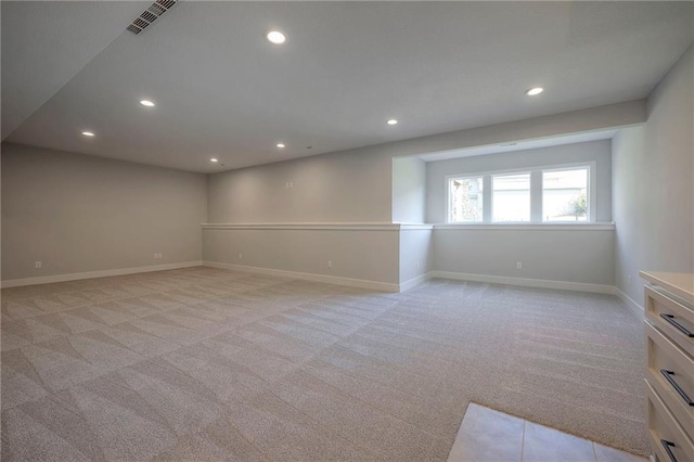 unfurnished room featuring visible vents, recessed lighting, light colored carpet, and baseboards