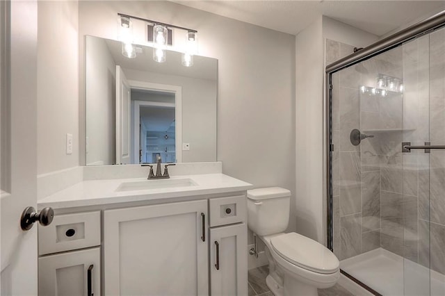 full bath with vanity, a shower stall, and toilet