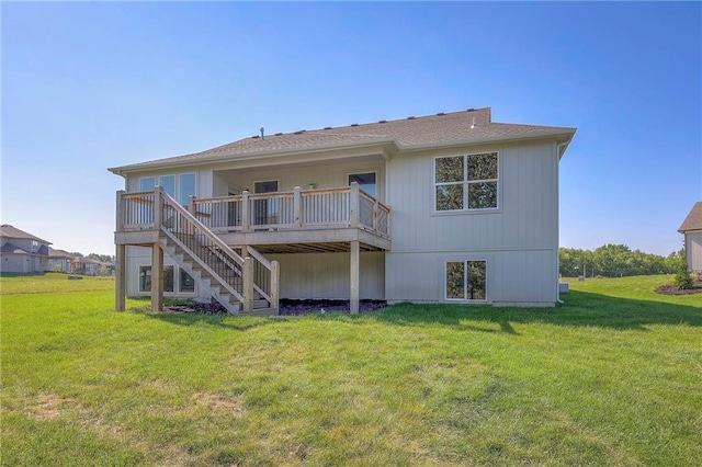back of house with stairs, a deck, and a lawn