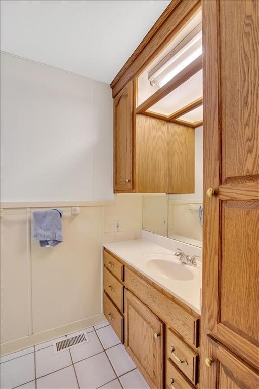 bathroom with vanity and tile patterned flooring