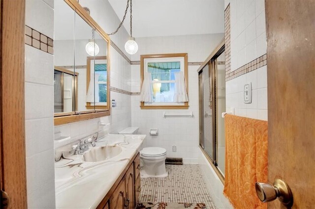 full bathroom featuring tile walls, tile patterned flooring, decorative backsplash, toilet, and vanity