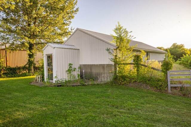 view of outbuilding with a lawn