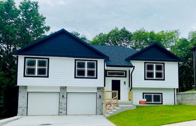 bi-level home with a garage and a front yard