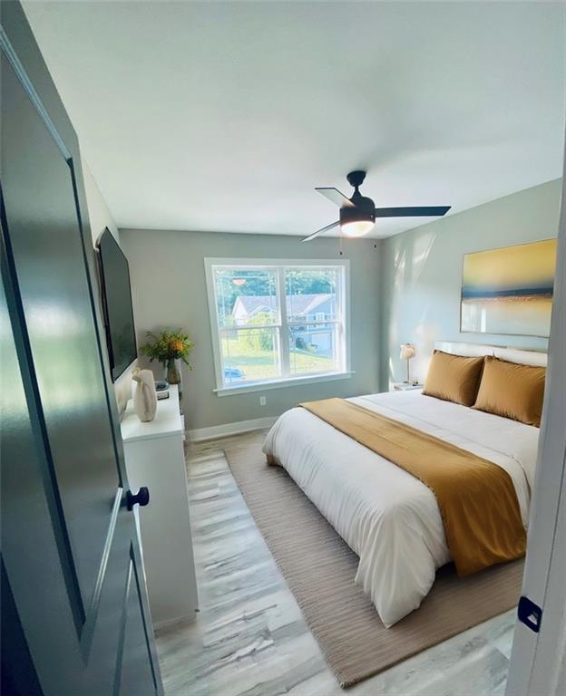 bedroom with ceiling fan and light wood-type flooring