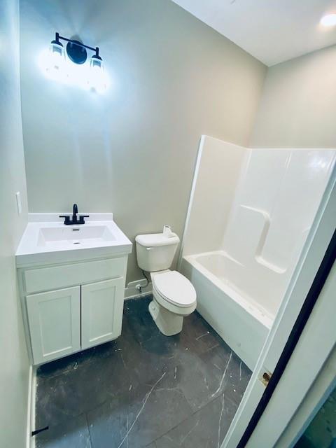 bathroom featuring marble finish floor, vanity, and toilet