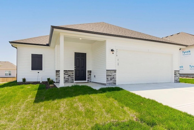 ranch-style house with a garage and a front lawn