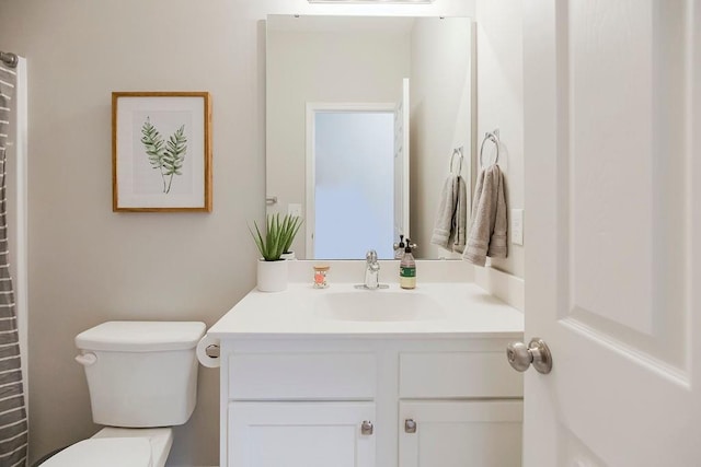 bathroom featuring vanity and toilet