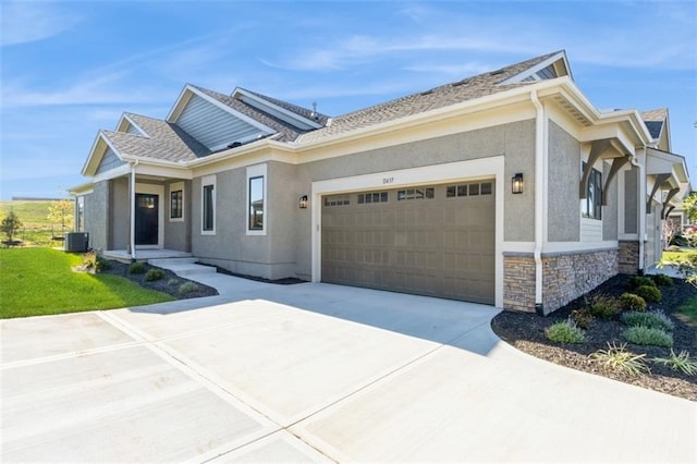 11437 S Waterford Dr, Olathe, KS 66061 - view of front of house featuring stucco siding, an attached garage, driveway, and stone siding