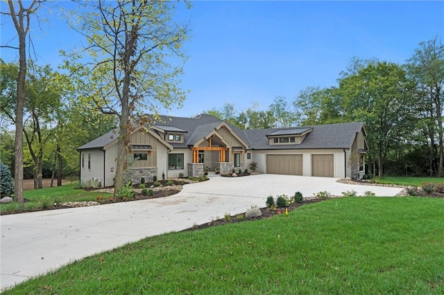 view of front of home featuring a front yard and a garage