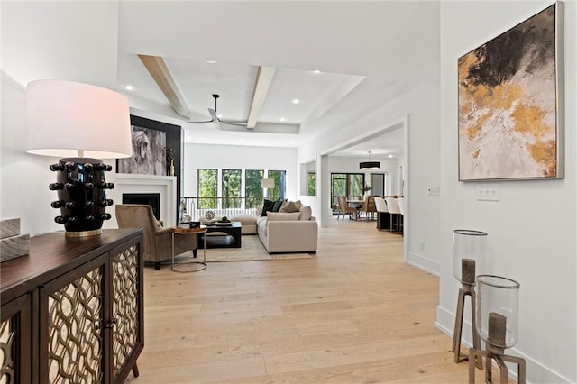 living room with light hardwood / wood-style floors and beam ceiling