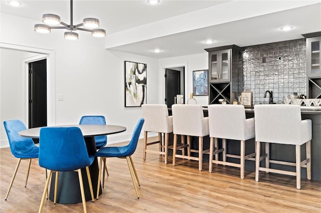 dining area featuring wood-type flooring and bar area