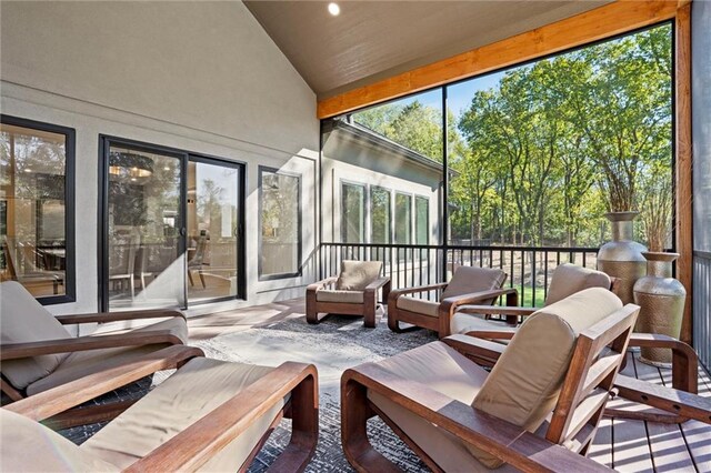 sunroom / solarium featuring lofted ceiling