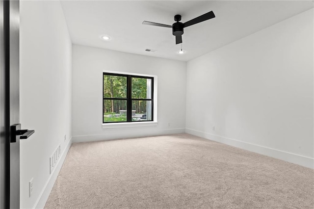 carpeted spare room with ceiling fan