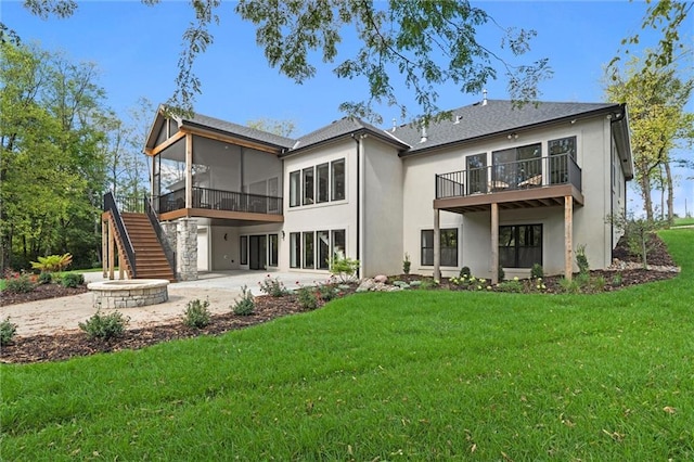 rear view of property featuring a sunroom, a patio area, and a yard