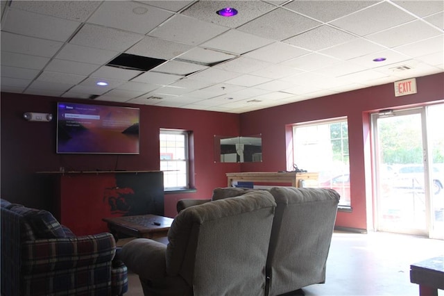 home theater featuring a paneled ceiling and plenty of natural light