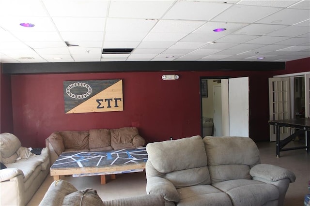 living room featuring a drop ceiling