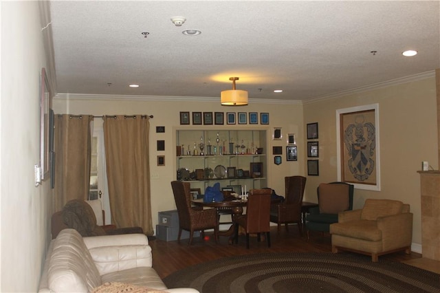 living room featuring dark hardwood / wood-style flooring, crown molding, and a textured ceiling