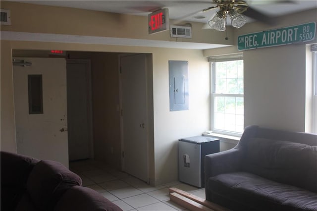 tiled living room featuring ceiling fan