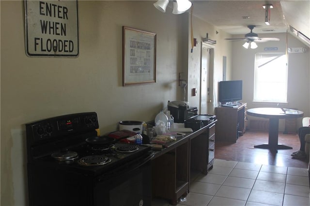 home office with light tile floors and ceiling fan