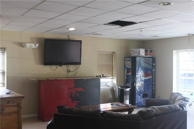 living room featuring a paneled ceiling