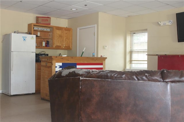 interior space with a paneled ceiling