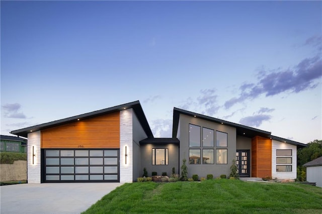 contemporary home featuring a yard and a garage